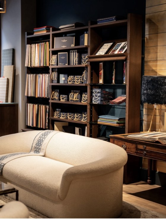 Shelves of Holland & Sherry cloth books in the Roomten fitting room