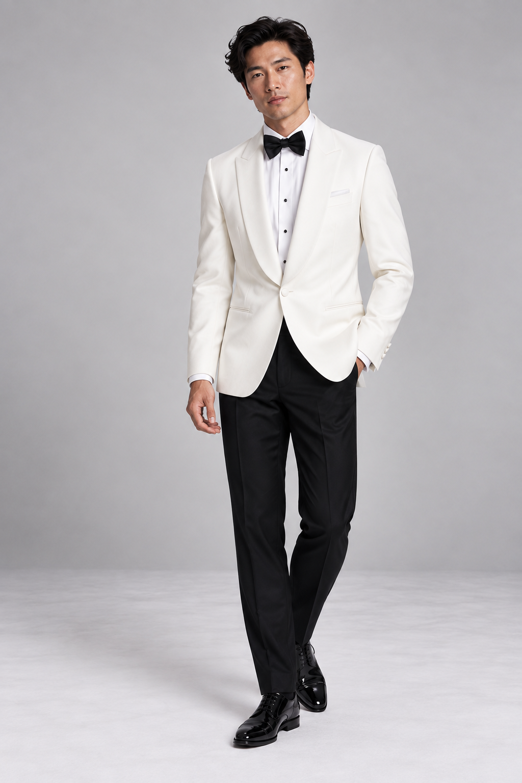 Roomten ivory dinner jacket with shawl collar, black evening trousers and bow tie