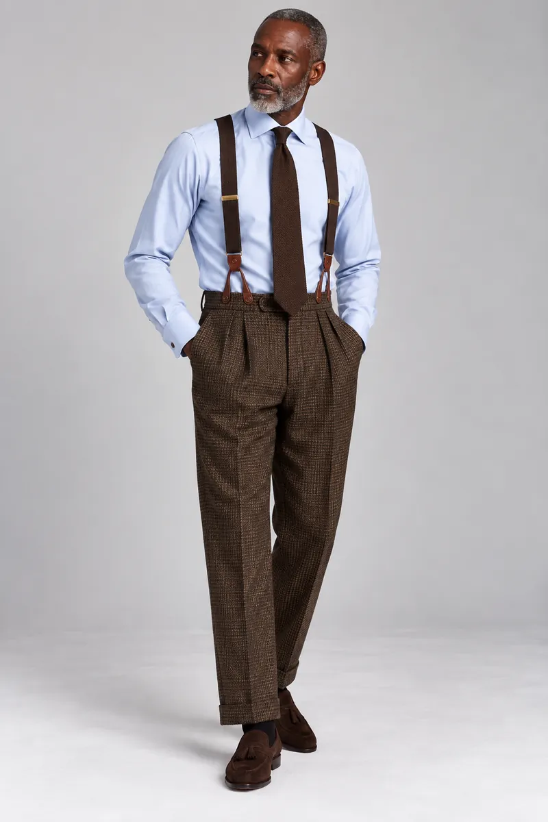 Brown houndstooth trousers with two pleats photographed on the wearer